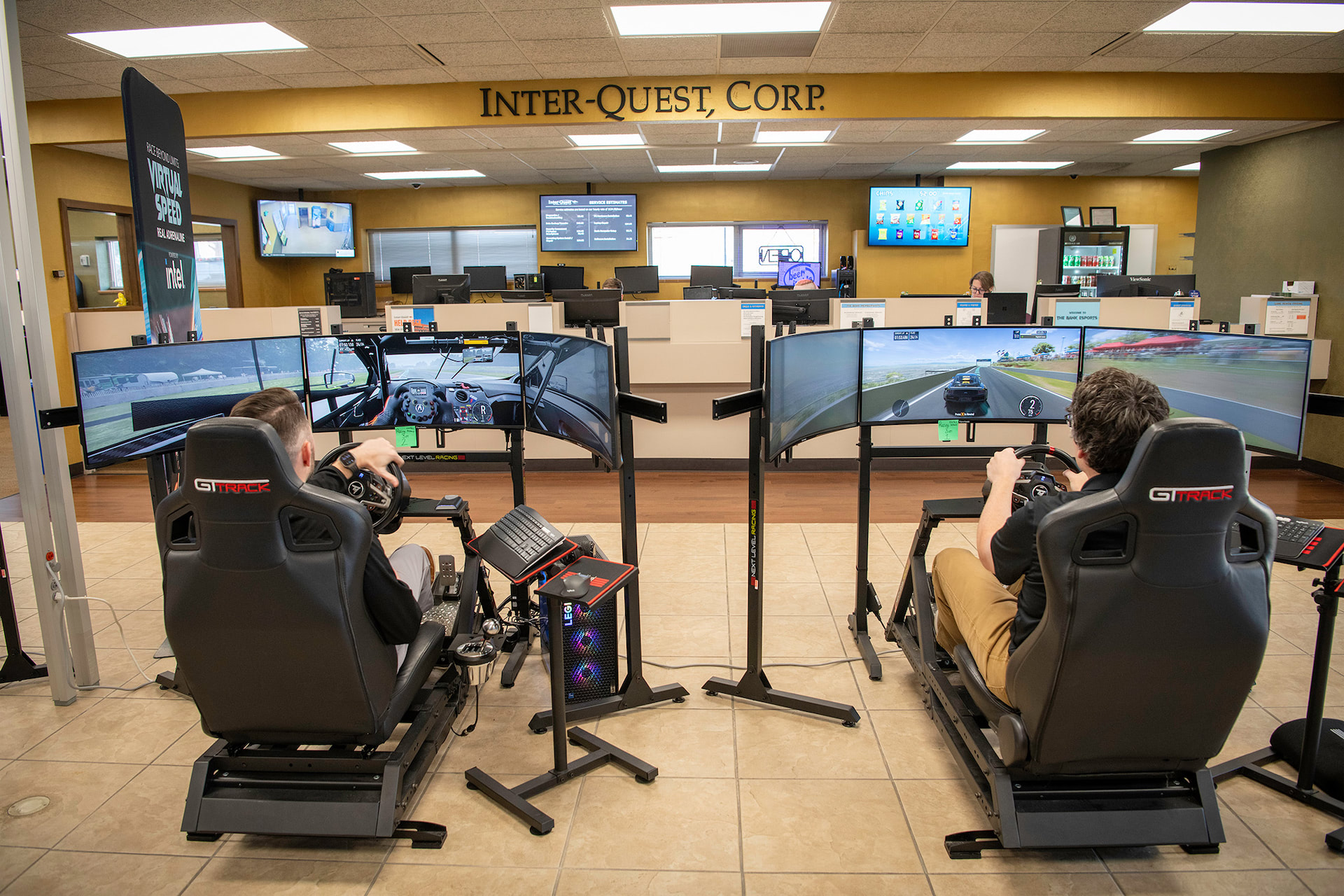 Two people competing on racing simulators side by side